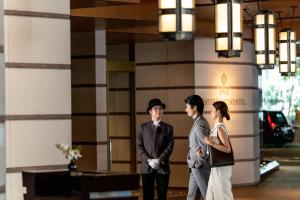 a man and a woman standing in front of a building at ANA InterContinental Tokyo by IHG in Tokyo