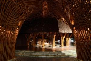 a building with a wooden structure with bamboo poles at Garrya Mù Cang Chải in Mù Cang Chải +204 photos