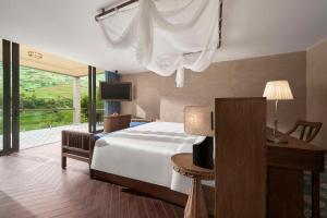 Ένα ή περισσότερα κρεβάτια σε δωμάτιο στο Garrya Mù Cang Chải