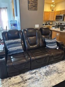 a brown leather couch sitting in a living room at Entire 3bedrooms 2bathrooms exquisite house in Williston +33 photos