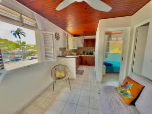 a kitchen and living room with a couch and a table at T2 - 50m du bourg de Sainte-Anne in Sainte-Anne