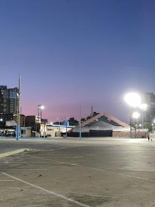 an empty parking lot at night with street lights at Loftjesus in Campina Grande