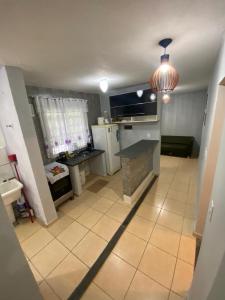a kitchen with a stove and a counter in a room at Paraíso Montanha e Mar in Peruíbe