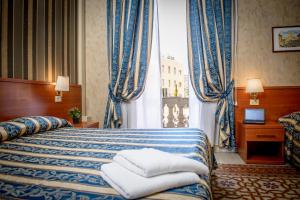 Habitación de hotel con cama y ventana en Hotel Emmaus en Roma