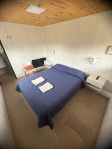 Ένα ή περισσότερα κρεβάτια σε δωμάτιο στο La Cascaruda Suites y Deptos