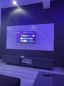 a large flat screen tv on a wall at Extravaganza Stay in Lagos