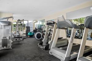 a gym with lots of treadmills and machines at StayCentral - The Park Port Melbourne in Melbourne