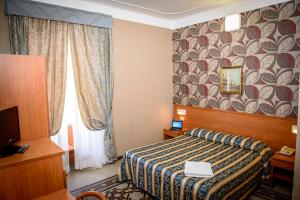 Postel nebo postele na pokoji v ubytování Hotel Emmaus