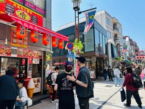 a group of people standing on a busy city street at 池袋アンプリルHouse3F Cozy for 1-3 guests in Tokyo
