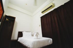 Postel nebo postele na pokoji v ubytování AZYA Hotel