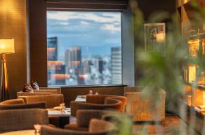 a restaurant with a view of a city from a window at ANA InterContinental Tokyo by IHG in Tokyo