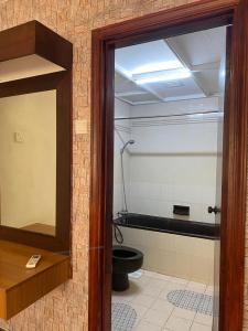 a bathroom with a toilet and a glass door at Mentari View Homestay in Port Dickson