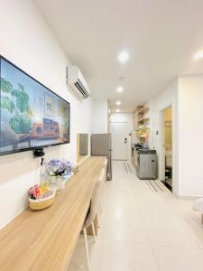 a living room with a large flat screen tv on the wall at 501 Modern Studio with Balcony & Kitchen in Ho Chi Minh City