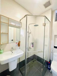 a bathroom with a sink and a shower at 501 Modern Studio with Balcony & Kitchen in Ho Chi Minh City