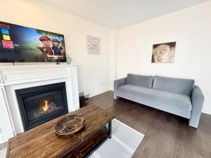 a living room with a couch and a fireplace at Elegant Retreat near Toronto Airport & Downtown in Brampton
