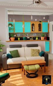 a living room with a couch and a table at La Note Verte - Parking gratuit devant l'entrée in Foix