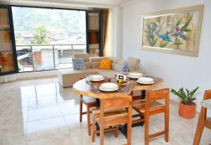 a living room with a table and a couch at Hummingbird in Chinchiná