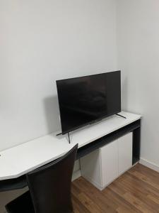 a white desk with a television on top of it at Mari's space city view in Nonthaburi