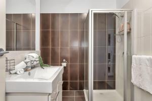 a bathroom with a sink and a shower at Urban Junction - Walk to Mawson Lakes Dining & Shops in Mawson Lakes +19 photos