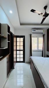 a bedroom with a large bed and a window at Satvic Sthal Apartment in Rishīkesh