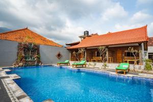 a swimming pool in front of a house at Rumah Gajah by Kubukubali in Pemuteran