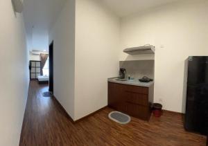 a small kitchen with a sink and a refrigerator at K Venue by IGVC in Donggongon