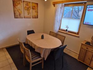 a dining room with a table and chairs and a window at Gruber Alexandra in Sankt Michael im Lungau