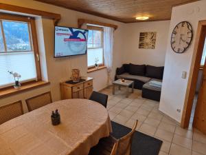 a living room with a table and a couch at Gruber Alexandra in Sankt Michael im Lungau +19 photos