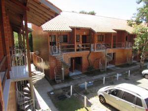 a house with a car parked in front of it at Casa De Praia Maranduba in Ubatuba