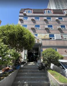 a building with stairs in front of a building at Sangmu Green Hotel in Gwangju