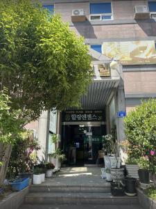 an entrance to a building with potted plants at Sangmu Green Hotel in Gwangju