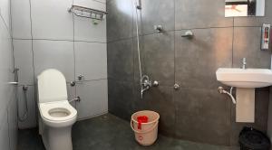 a bathroom with a toilet and a sink at Olivet Homestay in Vagamon +7 photos
