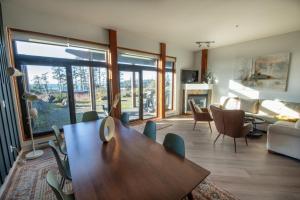 uma sala de estar com uma mesa e cadeiras de madeira em Big Beach Escape - Ucluelet - Sleeps 6 - Pet Friendly em Ucluelet