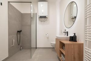 a bathroom with a shower and a sink and a mirror at Nika & Erik in Kranjska Gora