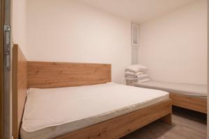 a bedroom with a bed with a wooden headboard at Nika & Erik in Kranjska Gora