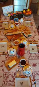 a table with plates and bowls of food on it at La chambre Nature chez les garçons in Saint-Paul-sur-Yenne
