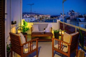 a patio with a table and chairs on a balcony at Flat with view of Marina Zeas in Piraeus