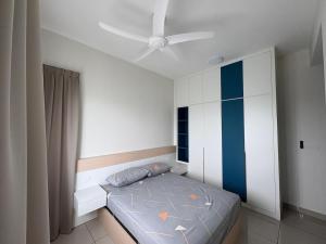 a bedroom with a bed and a ceiling fan at The Makcik's Homestay at Almyra Residence in Kajang +20 photos