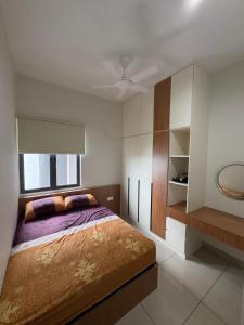 a bedroom with a bed and a window at The Makcik's Homestay at Almyra Residence in Kajang