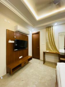 a hotel room with a television and a bed at Hotel Virat Inn in Bikaner