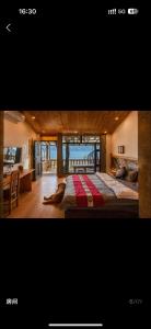 a bedroom with a large bed with a view of the ocean at Lugu Lake Motorcycle Travel Home in Zuosuo