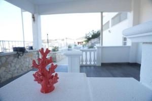 a red object sitting on top of a balcony at Bed and Breakfast Brezza Marina in Mattinata