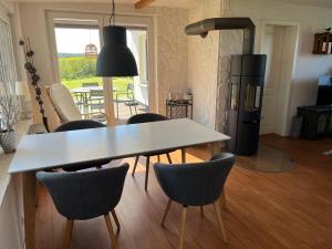 a kitchen with a table and chairs and a stove at Ferienhaus Solken mit großer Terrasse und Kaminofen in Plau am See