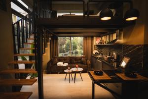 a room with a staircase and a living room at Sdluxurystudio in Durrës