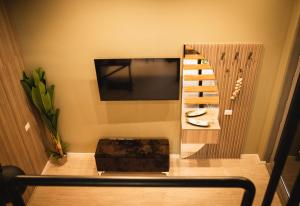 a living room with a television and a stair case at Sdluxurystudio in Durrës