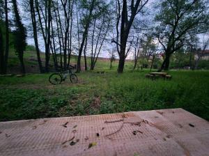 a bike parked in a park with a picnic table at Rebeka Luxury Apartment in Tryavna