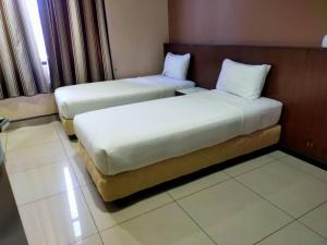 Postel nebo postele na pokoji v ubytování Langkawi Uptown Hotel