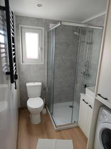 a bathroom with a toilet and a shower at Domek 2 Wdechy in Wdzydze Kiszewskie +11 photos