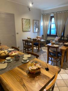 a living room with a table and chairs with food on it at Agriturismo Viticcio in La Morra