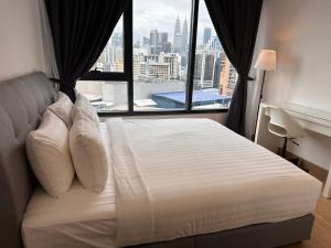 a bedroom with a bed with a large window at Lucentia Residence by EAS Maju property in Kuala Lumpur